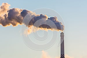 Chimney of an industrial plant discharges exhaust gases into the atmosphere