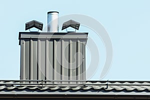 chimney with metal liner and canopies on sky background