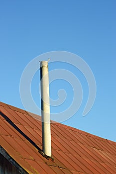 Chimney on an old tinny roof