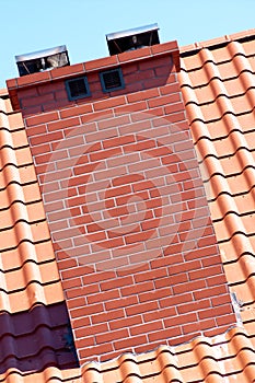 Chimney and red roof tiles