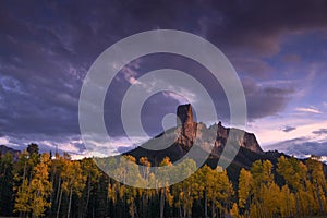 Chimney Rock at sunset with aspen trees in Fall Color