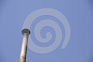 Chimney on the roof of the house against the blue sky