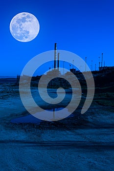 chimney on the sea at night