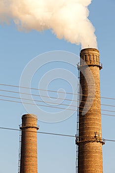 Chimney smoke with blue sky