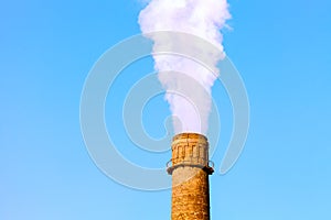 Chimney smoke with blue sky