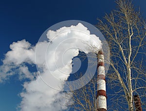 A chimney smoking right into the blue sky-5