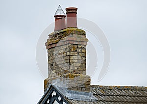 Chimney stack seen with a fitted anti-nesting bird cowl.