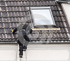 Chimney sweeper climbing the roof