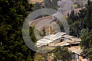 Chimney of a traditional factory during ceramics firing at the small city of Raquira