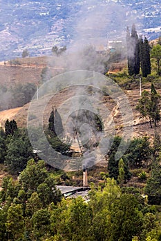 Chimney of a traditional factory during ceramics firing at the small city of Raquira