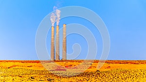 Chimneys of the soon to be decommissioned Salt River Project - Navajo Power Station in the desert landscape near Page, Arizona