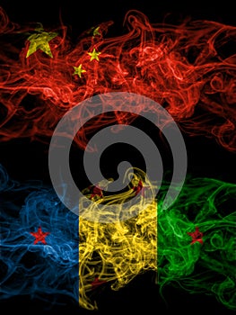 China, Chinese vs Ogoni people smoky mystic flags placed side by side. Thick colored silky abstract smoke flags