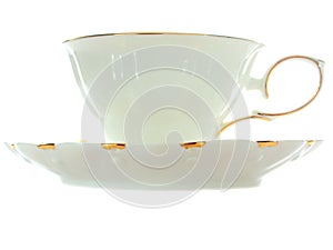 China cup with gold rim and saucer, side view