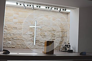 There is a beautiful light and shadow cross inside the solemn church photo