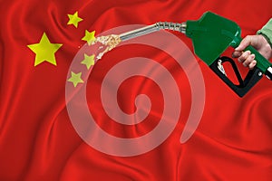CHINA flag Close-up shot on waving background texture with Fuel pump nozzle in hand. The concept of design solutions. 3d rendering
