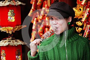 China girl eating candied fruit