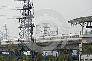China, Guangzhou - October 19, 2019: Guangzhou City Railway Station. A high-speed train rushes along the railway located above the