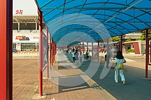 China, Guangzhou - October 19, 2019: Guangzhou City Railway Station. People with bags go to the station, board a high-speed train.