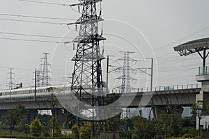 China, Guangzhou - October 19, 2019: Guangzhou City Railway Station. A high-speed train rushes along the railway located above the