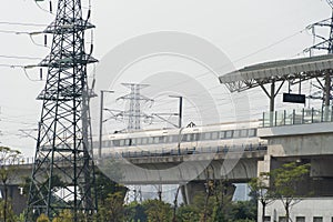 China, Guangzhou - October 19, 2019: Guangzhou City Railway Station. A high-speed train rushes along the railway located above the