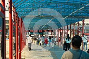 China, Guangzhou - October 19, 2019: Guangzhou City Railway Station. People with bags go to the station, board a high-speed train.