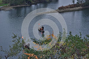 Fishman rowing boat in canoe Lantern