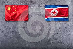 China and North korea flag on concrete background
