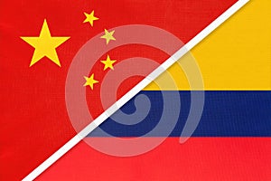 China or PRC vs Colombia national flag from textile. Relationship between asian and american countries