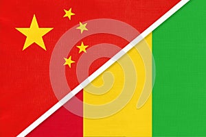 China or PRC vs Guinea national flag from textile. Relationship between Asian and African countries