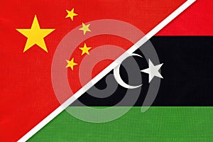 China or PRC vs Libya national flag from textile. Relationship between Asian and African countries