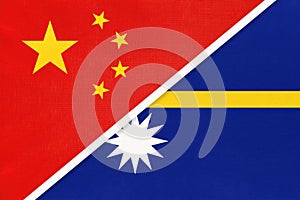 China or PRC vs Nauru national flag from textile. Relationship between Asian and Oceania countries