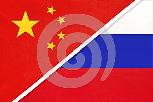 China or PRC vs Russia national flag from textile. Relationship between asian and european countries