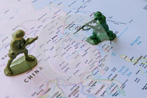 China and Taiwan conflict or war concept photo with figure soldiers on the map