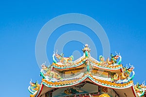 China temple roof with Chinese style dragon statue and blue sky