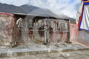 China,Tibet, Lhasa. The ancient monastery Pabongka. Tibetan prayer wheels or prayer`s rolls of the faithful Buddhists