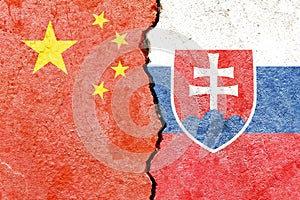 China vs Slovakia flags on cracked wall