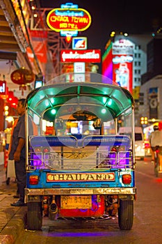 CHINATOWN, BANGKOK, THAILAND - 12 APRIL 2016: Tuk tuk taxi parked near street market in Chinatown on Yaowarat road, the main stree