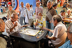 Chinatown, Singapore - 11 2018: Old man playing Xiangqi, chinese chess