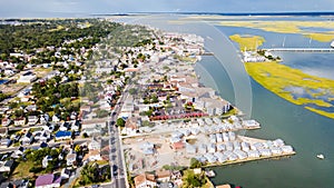 Chincoteague Island, marinas, houses and motels with parking lots. bridge and road along the bay. Drone view photo