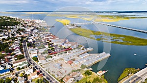 Chincoteague Island, marinas, houses and motels with parking lots. bridge and road along the bay. Drone view photo
