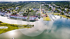 Chincoteague Island, marinas, houses and motels with parking lots. Road along the bay. Drone view photo