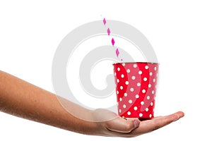 chinds hand holding red paper cup