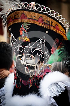 Chinelos are a traditional colorful costumed dancer in carnaval.