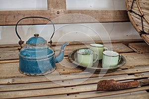 Antique teapot and cups on bamboo table