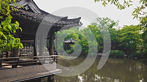 Chinese architecture by water in Shenyuan Shen Garden scenic area in Shaoxing, China