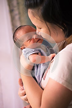 Chinese Asian Malaysian mother and her newborn infant baby boy
