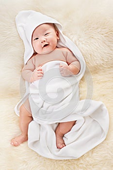 Chinese baby boy covered with white blanket