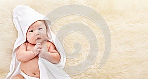 Chinese baby boy covered with white blanket