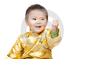 Chinese baby boy with traditional costume and thumb up