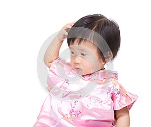 Chinese baby girl scratching head